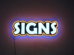 SIGNS! internally lighted channel letters with neon border and multi-colored backlighting by Signs Manufacturing